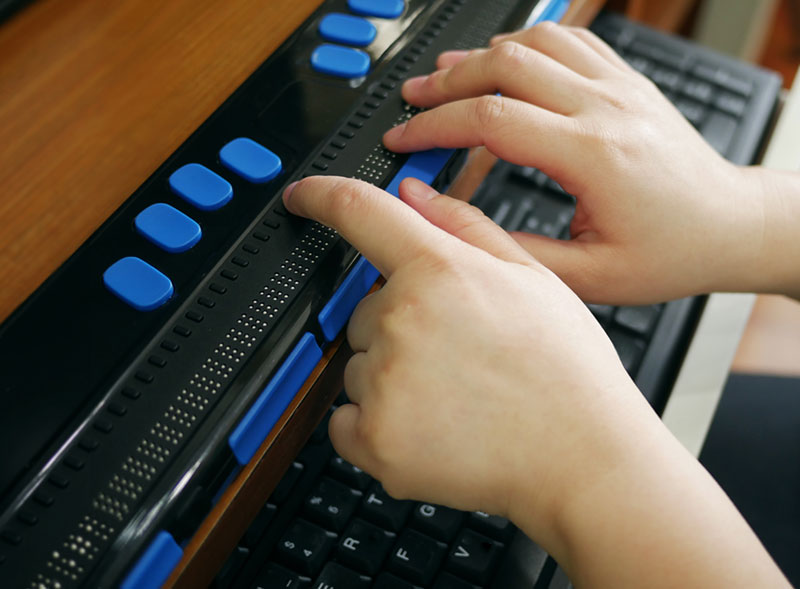 person using brail keyboard