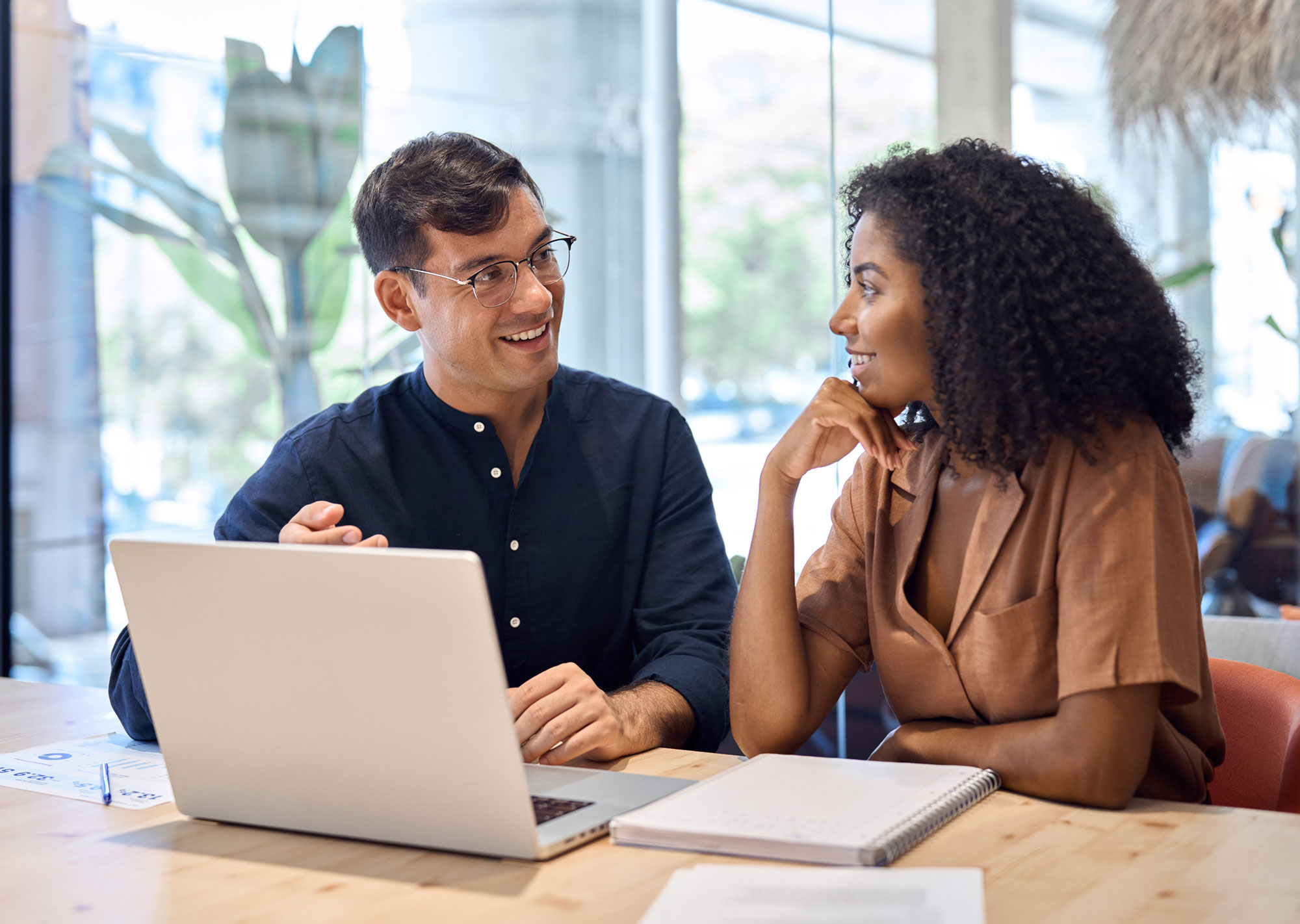 Man and woman marketing team working with AI tools on computer