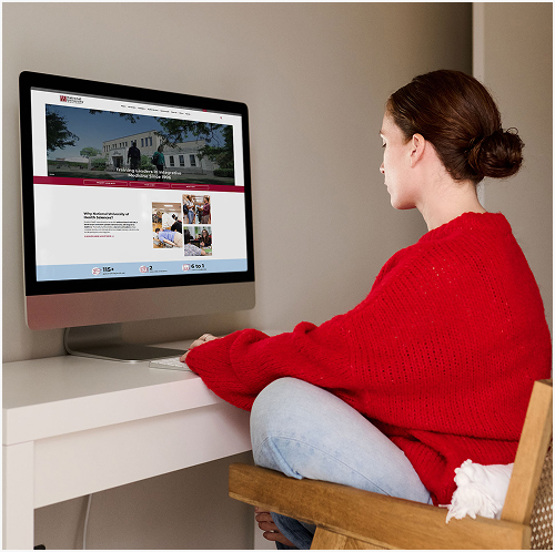 student on computer looking at NUHS website