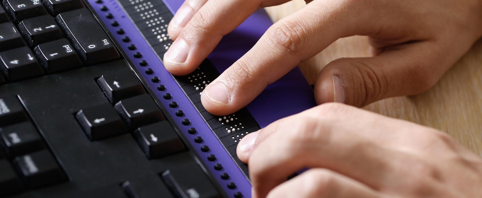visually impaired person using braille keyboard