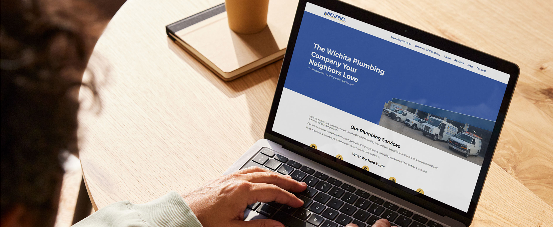 person looking at benefiel website in cafe