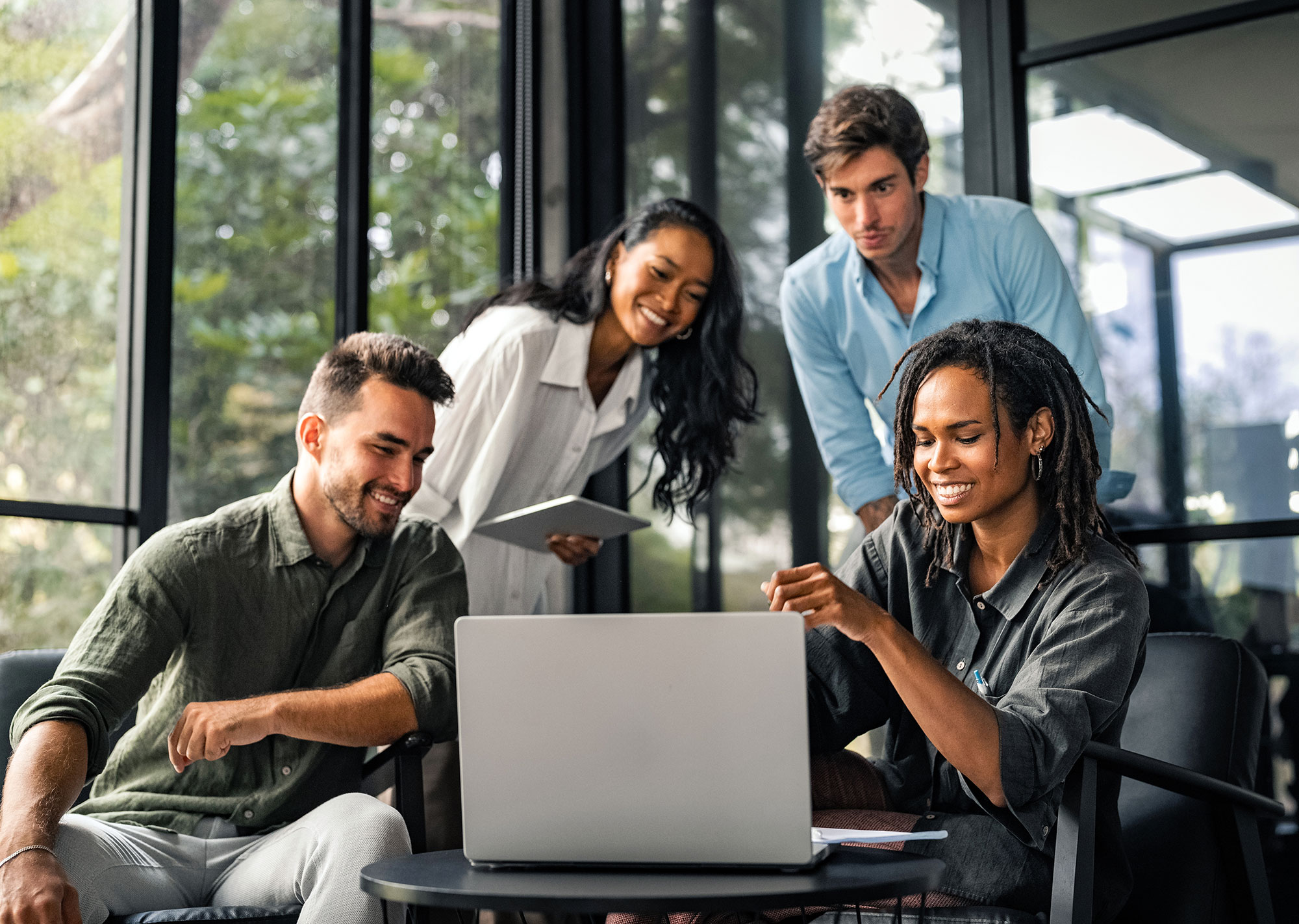 marketing team sitting around a computer working on their website’s accessibility