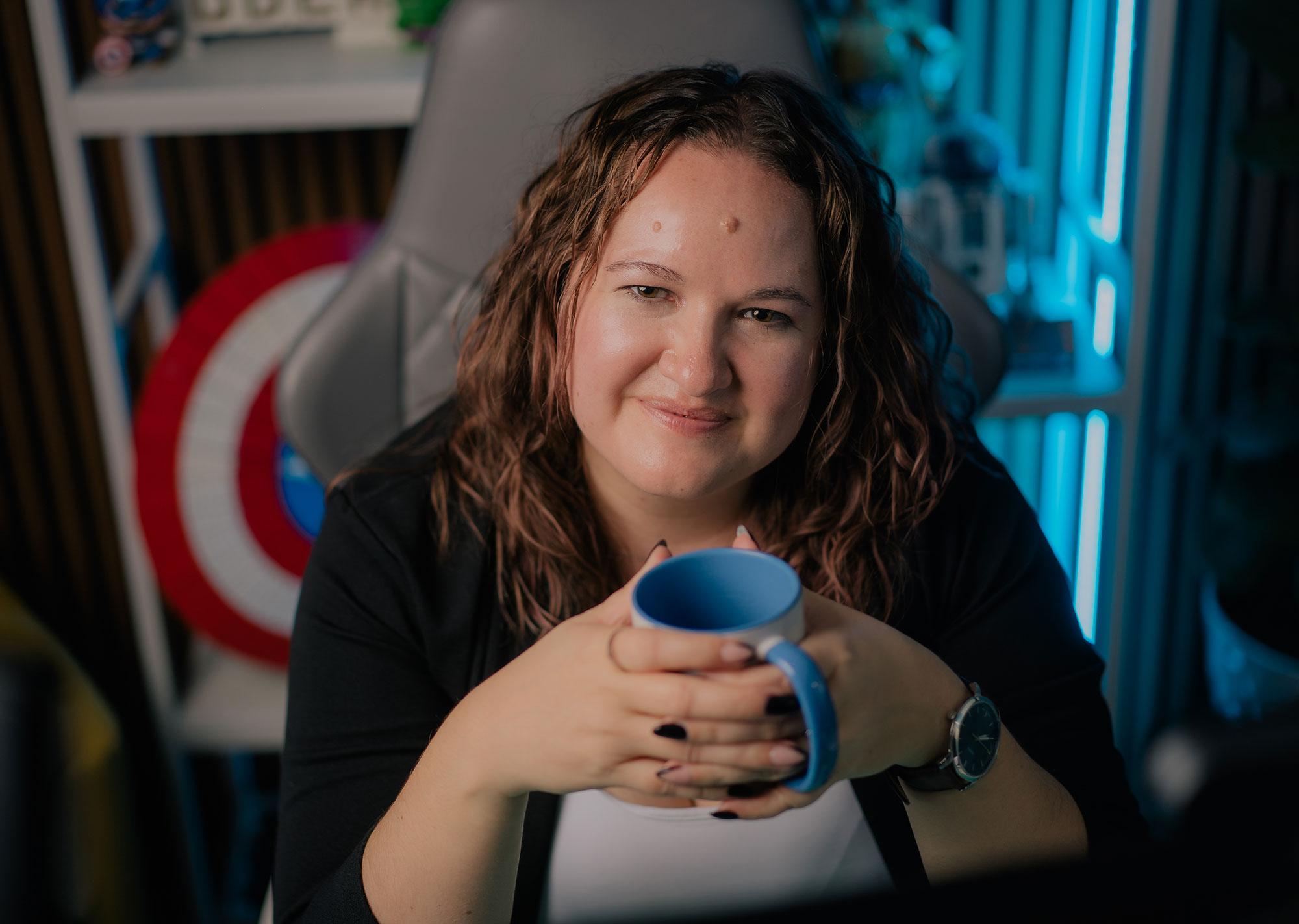 Marisa VanSkiver holding a coffee cup at her computer before performing web accessibility testing